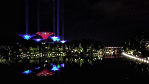 Illuminated reflection of sky in water at night
