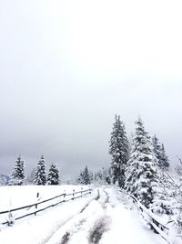 Snow covered landscape against clear sky