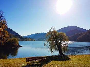 Scenic view of lake and mountains against clear sky