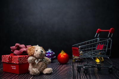 Close-up of toys on table against black background