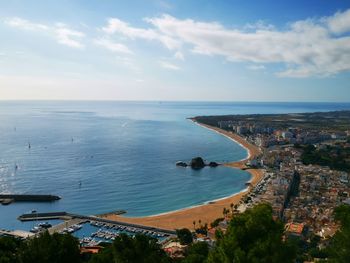 High angle view of townscape by sea against sky