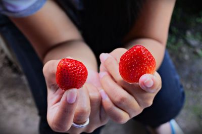Close-up of girl holding strawberries