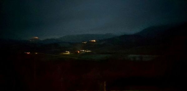 Illuminated mountain against sky at night