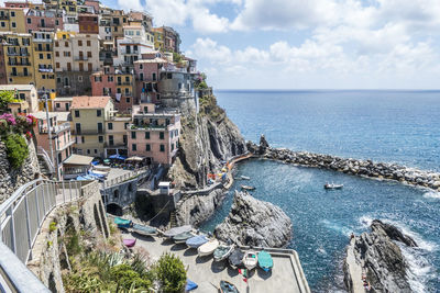 High angle view of buildings by sea against sky