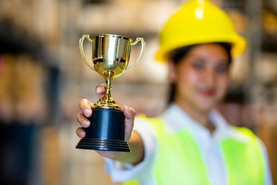 Portrait of woman holding trophy