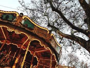 Low angle view of carousel against sky