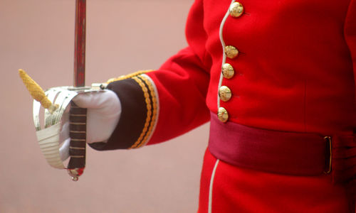 Midsection of man holding sword