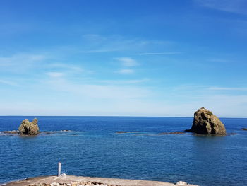 Scenic view of sea against blue sky