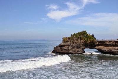 Rocks in sea against sky