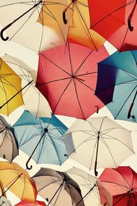 Low angle view of colorful umbrellas against sky