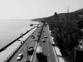 High angle view of highway by river against clear sky