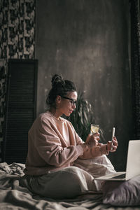Midsection of man using mobile phone