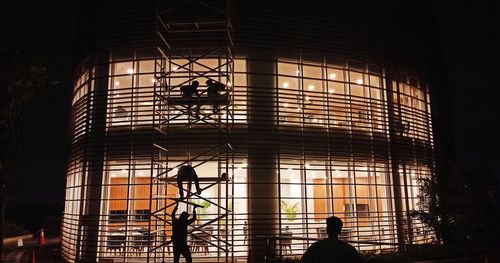 Silhouette people working in modern building