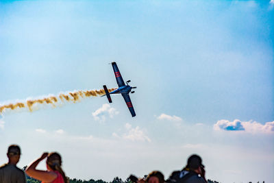Low angle view of airplane flying against sky