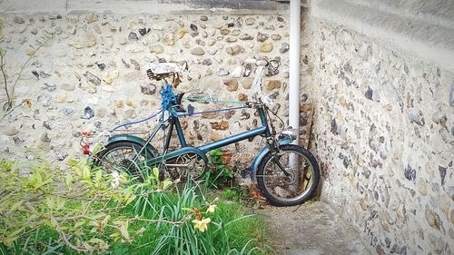 Bicycle parked against wall