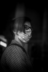 Close-up of woman wearing mask standing outdoors