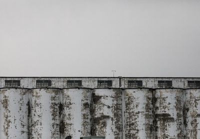 Wall by building against clear sky