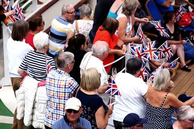 High angle view of people with british flags in city