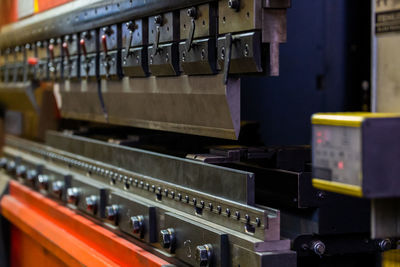 Closeup view of industrial sheet bending press brake with tool