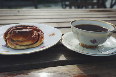 Close-up of tea cup and dessert on table