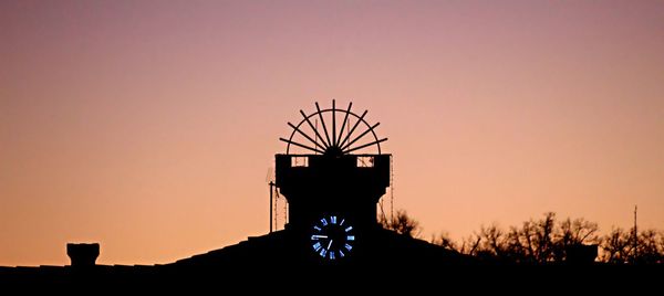 Silhouette plants on field against clear sky during sunset
