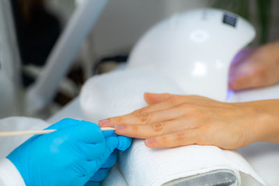 Close-up of woman hand holding finger