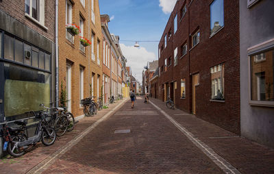 Street amidst buildings in city against sky