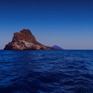 Scenic view of sea against clear blue sky at night