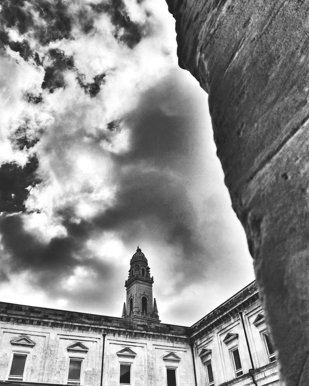 architecture, built structure, building exterior, low angle view, sky, religion, place of worship, church, history, spirituality, cloud - sky, old, cloud, high section, day, cloudy, the past, outdoors