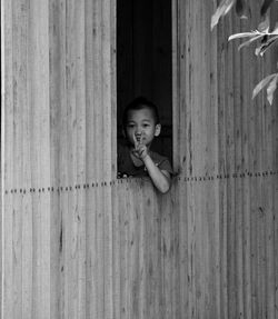 Portrait of cute girl peeking outdoors