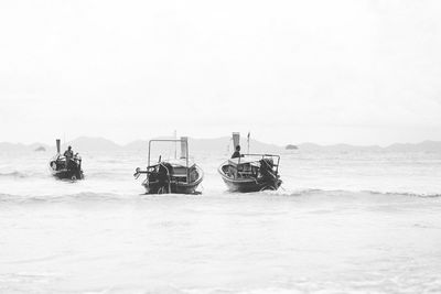 People on beach against sky