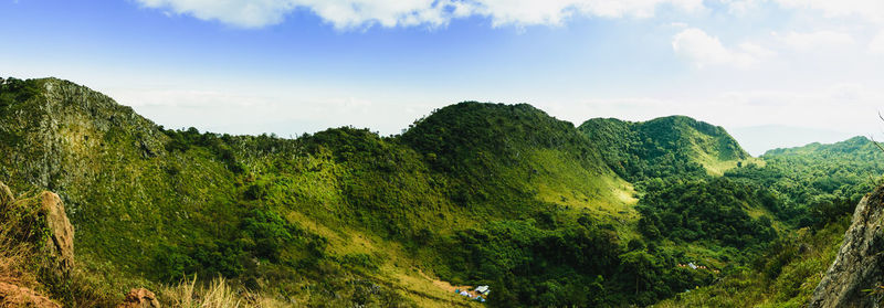 Panoramic view of green landscape against sky