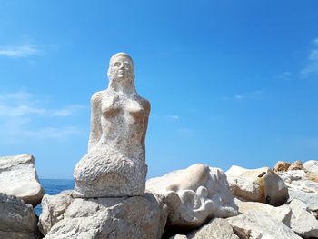 Low angle view of statue against blue sky