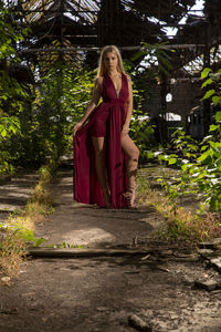 Portrait of a young woman against plants