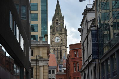 Low angle view of clock tower against sky