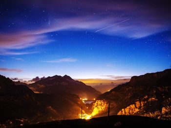 Scenic view of mountains against sky at night