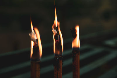 Close-up of lit candles in temple