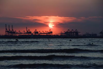 Scenic view of sea against orange sky