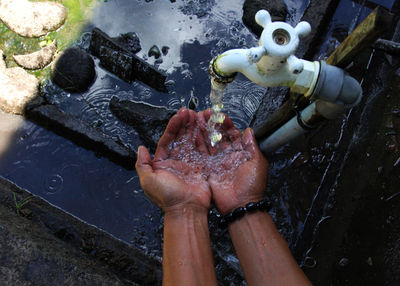 Cropped image of man washing hands