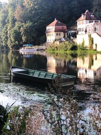 Scenic view of river by buildings