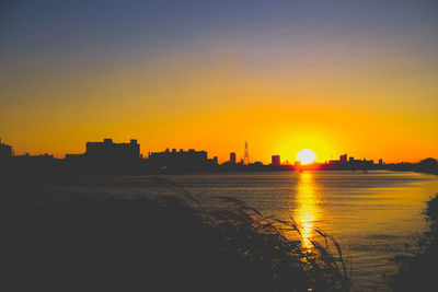 Silhouette of city during sunset