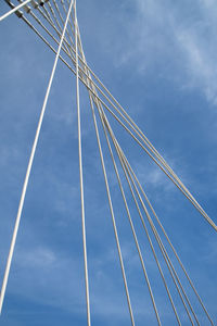 Low angle view of suspension bridge against sky