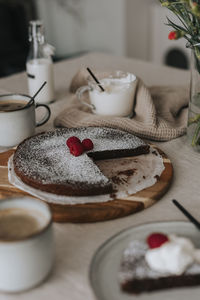 Freshly baked chocolate cake with raspberries on table