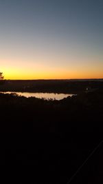 Scenic view of sea against clear sky during sunset