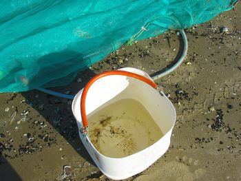 High angle view of sunglasses on beach