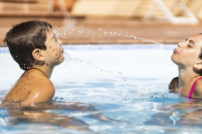 Portrait of a smiling  kids on a pool