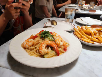 Tasty seafood shrimp spaghetti pasta on the marble table in a italian bistro restaurant