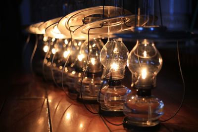 Close-up of illuminated light bulb on table