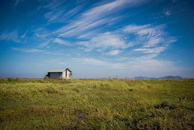 Built structure on field against sky