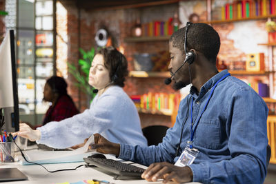 Young woman using laptop while sitting in cafe
